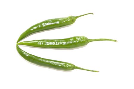 Green hot chili peppers on white backgroundの写真素材