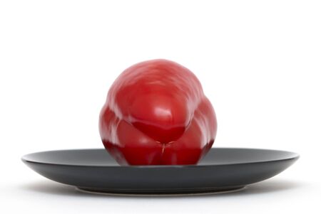 Red pepper on a black plateの写真素材