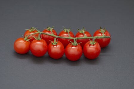 Cherry tomatoes on a black backgroundの写真素材