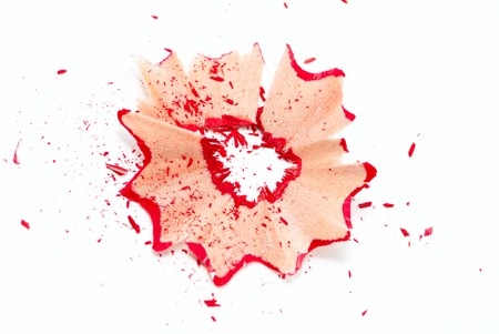 Red pencil shavings isolated on whiteの写真素材