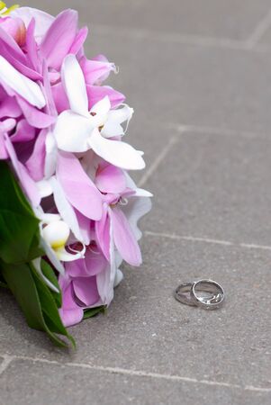 Two wedding rings with Wedding Bouquetの写真素材