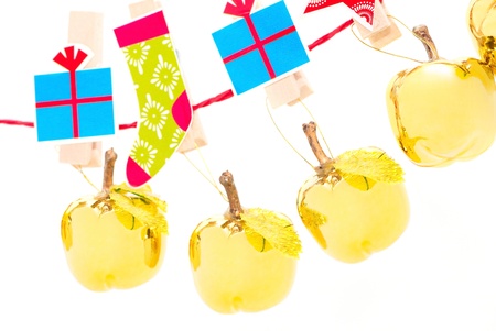 Christmas decorations - golden apples hanging in a rowの写真素材