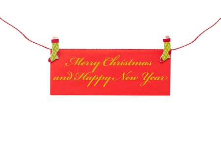 Christmas greeting card hanging with clothespinの写真素材