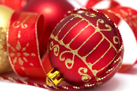 Christmas baubles with curly ribbon isolated on whiteの写真素材
