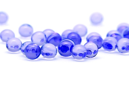 Transparent blue capsules isolated on whiteの写真素材