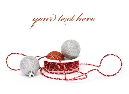 Christmas baubles with ribbon on white background (with sample text)の写真素材