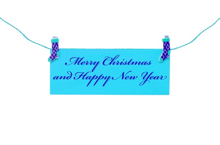 Christmas greeting card hanging with clothespinの写真素材
