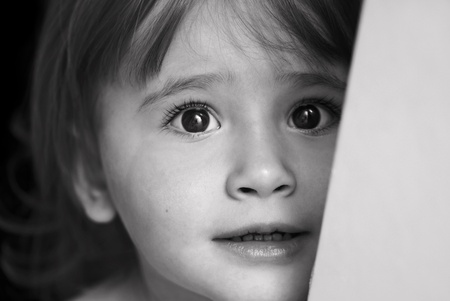 Little girl with eyes full of scare and sadness