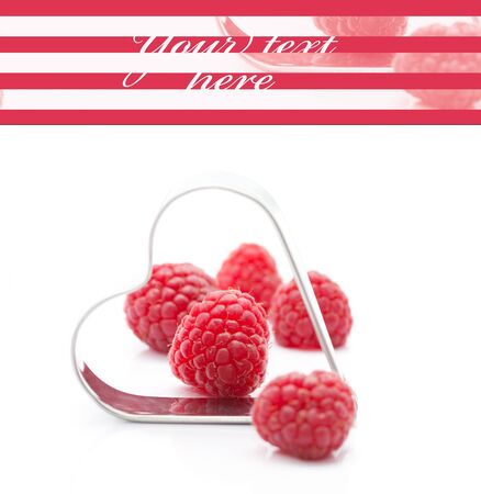 Fresh raspberries with metallic heart (easy removable text)の写真素材