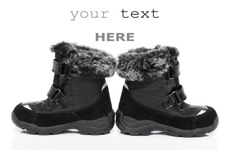 Black child's winter boots isolated on white background (with space for text)の写真素材