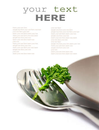 Parsley with fork and spoon isolated on a white background (with sample text)の写真素材