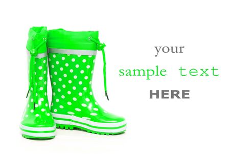 Green rubber boots for kids isolated on white background (with space for text)の写真素材