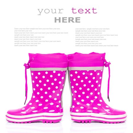 Pink rubber boots for kids isolated on white background (with sample text)の写真素材