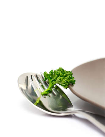 Parsley with fork and spoon isolated on a white background (with sample text)の写真素材