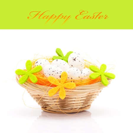 Easter eggs in basket isolated on white background (with space for text)の写真素材