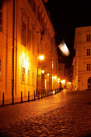 Narrow alley with lanterns in Prague at night の写真素材