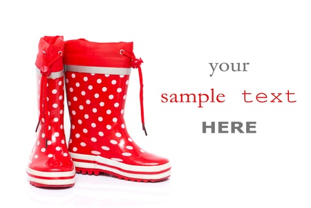 Red rubber boots for kids isolated on white background (with space for text)の写真素材