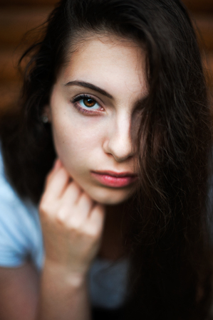 Closeup beauty portrait of young sensual beautiful brunette girl with long dark hair.の写真素材