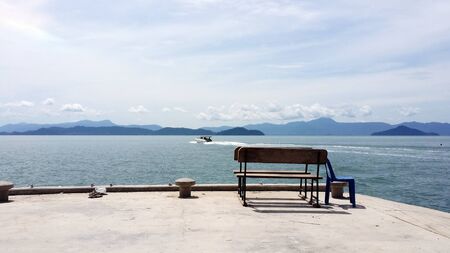 empty chairs on harborの写真素材