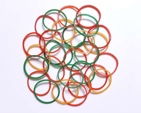 Pile of multi-color elastic band on white background