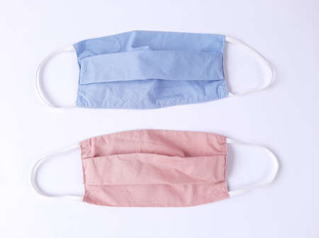 Blue and pink fabric face masks isolated on white backgroundの写真素材