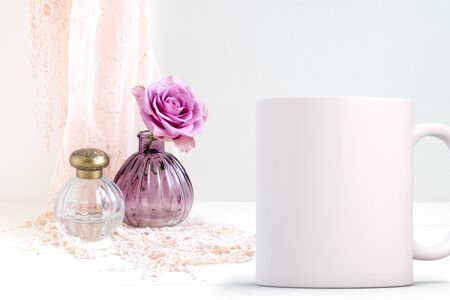 White blank coffee mug mock up, next to a rose in a small glass vase. Add custom design or quote on to coffee mugの写真素材