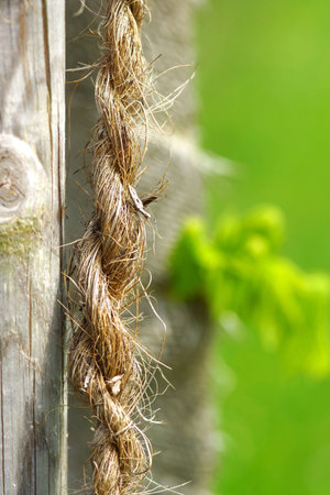 A rope hanging from a wooden fence.の素材
