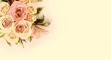 Delicate floral arrangement of cream roses and pink astromelias. Background for greetings, invitations to a holiday, wedding, engagement.の写真素材