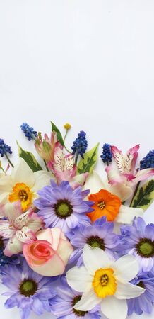 A delicate floral arrangement of spring flowers-daffodils, chrysanthemums and Alstroemeria. Pastel...