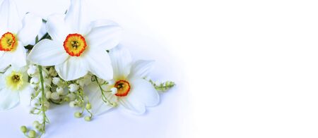 Spring bouquet of daffodils and lilies of the valley on a white background. Delicate flower arrangement. Background for cards, greetings, invitations.の写真素材