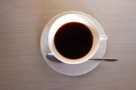 Cup of coffee on wooden table. Top view. Copy space.の写真素材