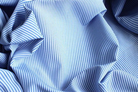 Blue and white striped fabric as a background. Texture. Pattern