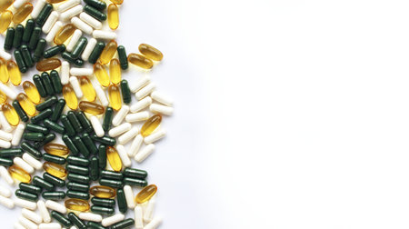 Colorful medicine pills and capsules on white background with copy space.