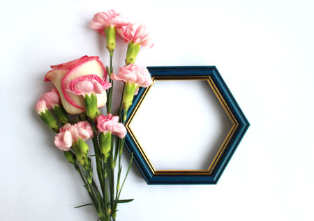 Frame with pink flowers on white background. Flat lay, top view