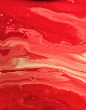 Abstract background of acrylic paint in red and white tones, close-up