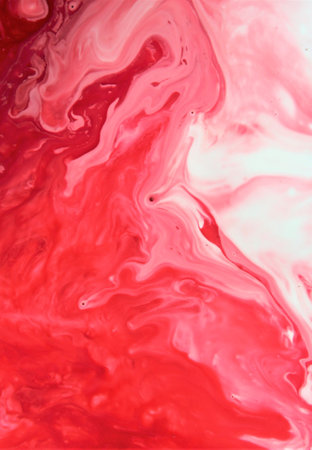 Red and white paint mixing in water. Abstract background for design.の写真素材