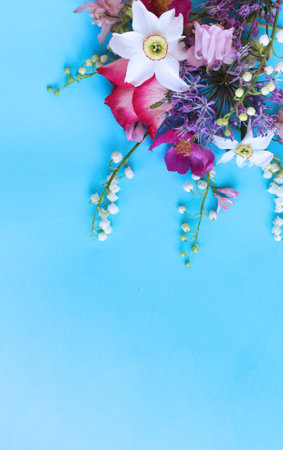 Spring flowers on blue background. Flat lay, top view, copy spaceの写真素材