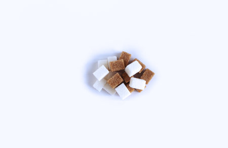 White and brown sugar cubes isolated on white background. Top view.の写真素材
