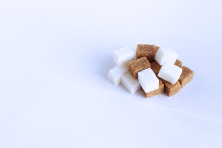White and brown sugar cubes isolated on white background with copy space.の写真素材