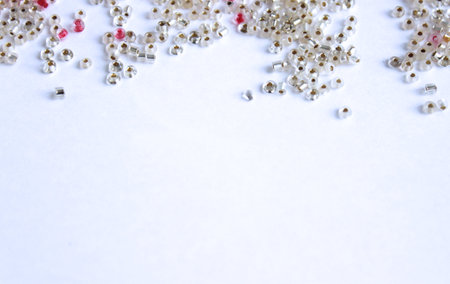 Pearl beads scattered on a white background. Place for text.の写真素材