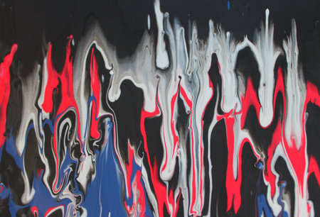 abstract background of red and blue paint on a black wall.