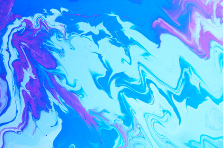 abstract background with blue and pink marbling ink patterns in water