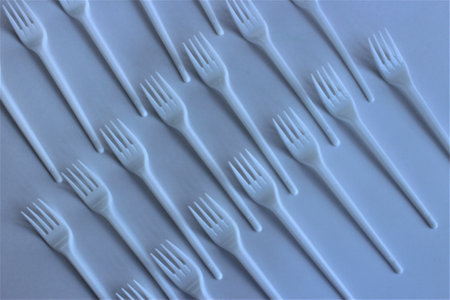 Plastic forks on a blue background. 3d rendering. Top view.の写真素材