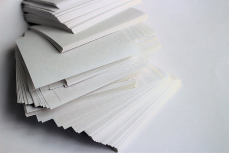 Stack of white business cards on white background. Copy space for text.