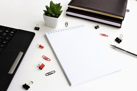 Office desk table with laptop, supplies and coffee cup. Top view with copy space