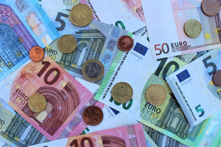 Euro banknotes and coins as a background, closeup of photoの写真素材