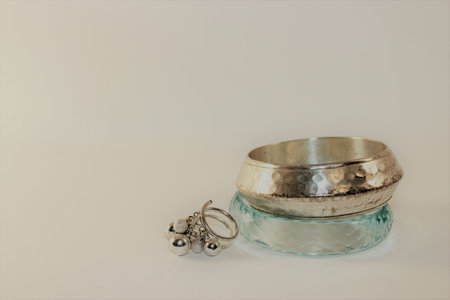 silver rings on a glass jar on a white background.