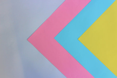 Abstract geometric paper background with pastel pink, blue and yellow colors