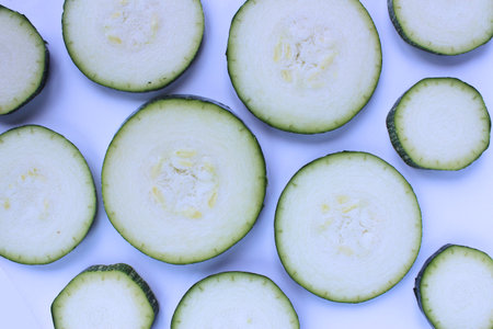 Zucchini slices on white background. Top view. Flat lay.の写真素材