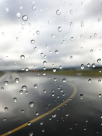 Raindrops on the window of the car. Rainy day.の写真素材